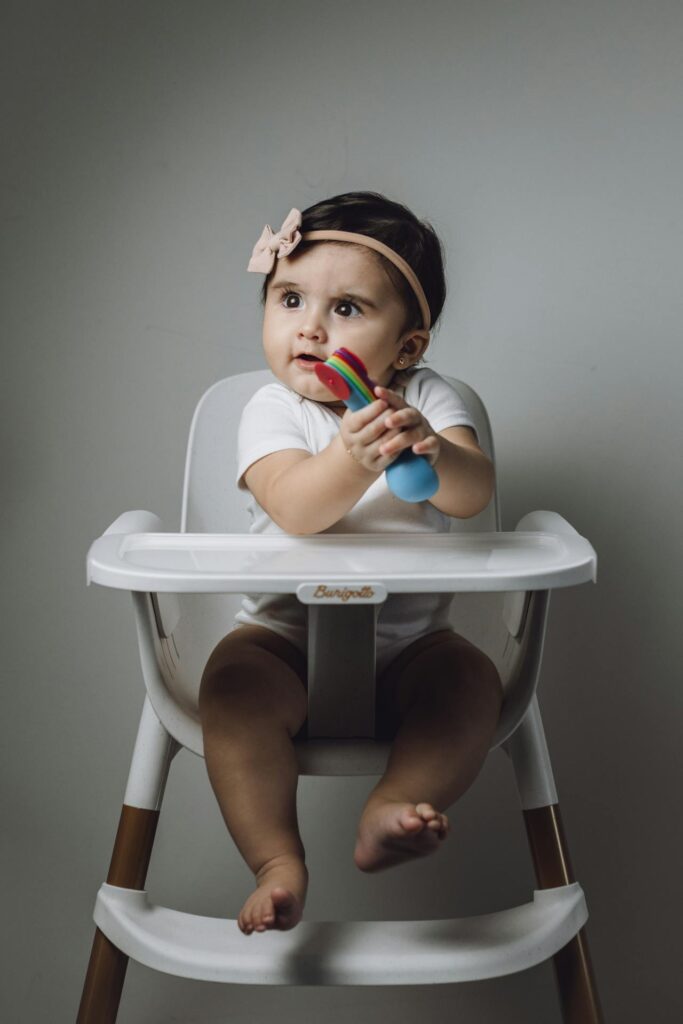 baby girl holding toy